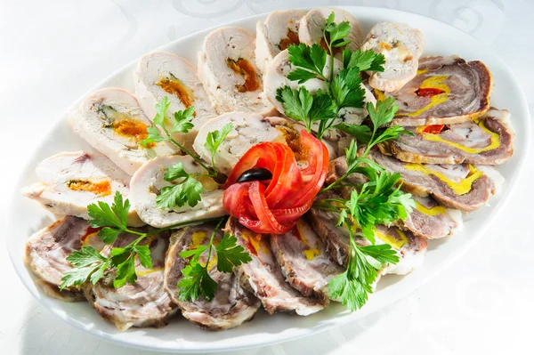 Plate with sliced cooked meat with vegetables and greens. — Stock Photo, Image