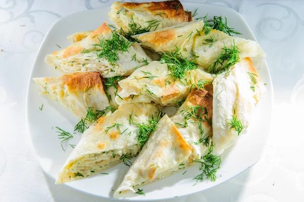 Grilled rolls of bread lavash with cheese inside. — Stock Photo, Image