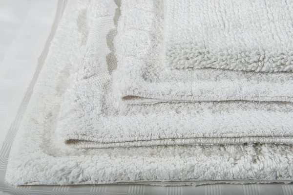 Stack of white bath mats . Stok Gambar