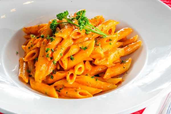 Plate of macaroni dish with tomato sauce. — Stock Photo, Image