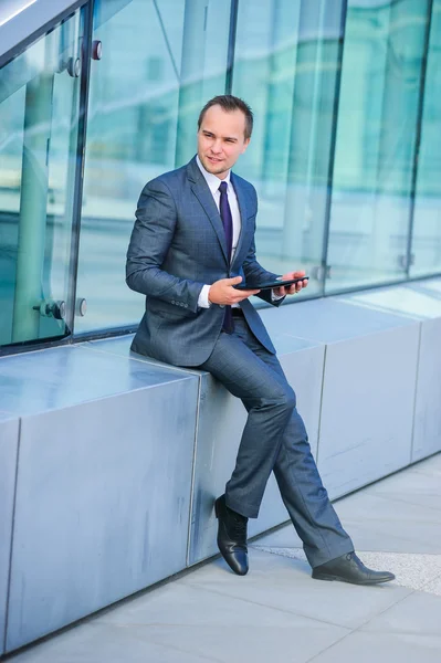 Portrait of yang businessman in suit outdoors. — Stock Photo, Image