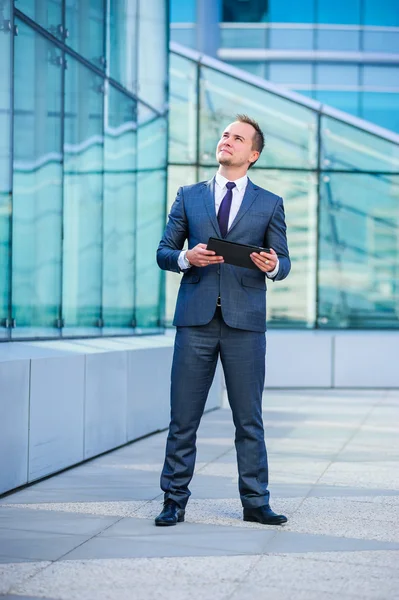 Portrait of yang businessman in suit outdoors. — Stock Photo, Image