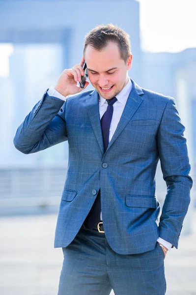 Portrait of yang businessman in suit outdoors. — Stock Photo, Image