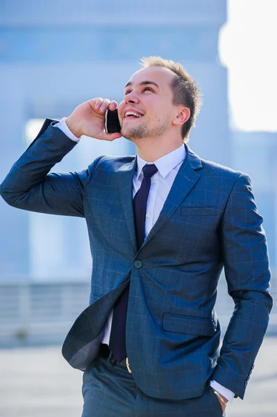 Portrait of yang businessman in suit outdoors. — Stock Photo, Image