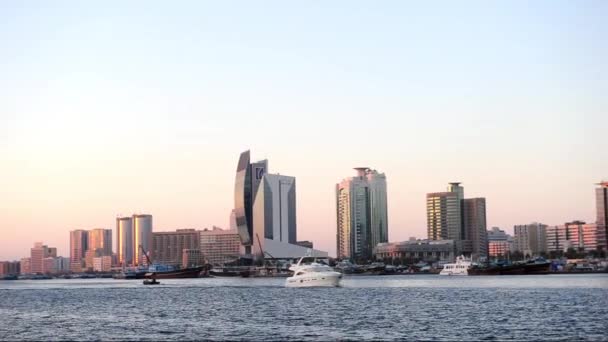 Motorboat rides alone Dubai creek at sunset time. — Stock Video