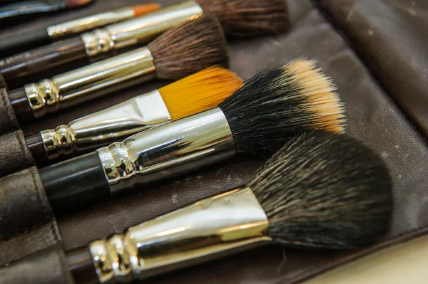 Make-up brushes on grey background. — Stock Photo, Image