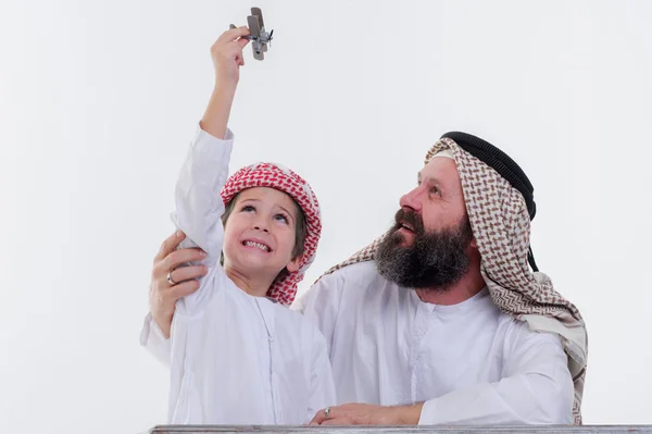 Middle eastern father and son playing with toy plane. — Stock Photo, Image