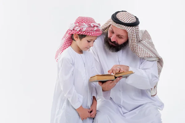 Arabic father teaching to read Koran his son. — Stock Photo, Image