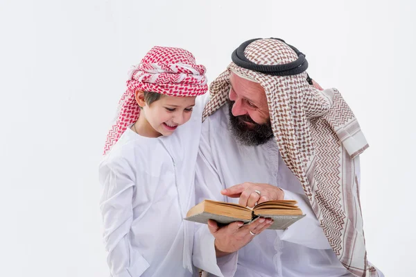 Arabic father teaching to read Koran his son. — Stock Photo, Image