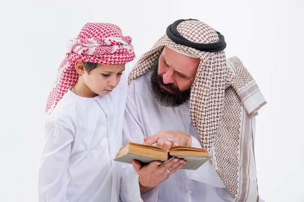 Arabic father teaching to read Koran his son. — Stock Photo, Image