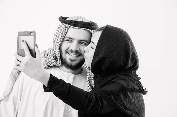 Arabic couple take self pictures with sell phone. — Stock Photo, Image