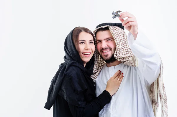 Middle eastern way dressed yang souple playing with toy plane. — Stock Photo, Image