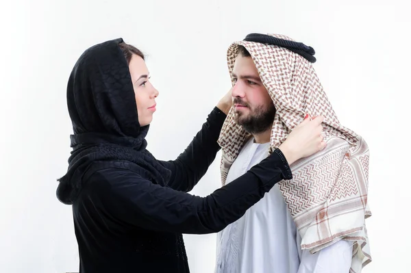 Arabic wife fixing her husband head scarf. — Stock Photo, Image