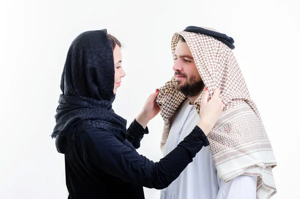 Arabic wife fixing her husband head scarf. — Stock Photo, Image