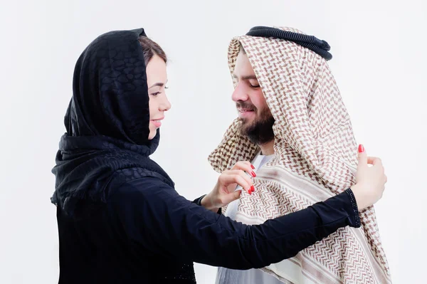 Arabic wife fixing her husband head scarf. — Stock Photo, Image