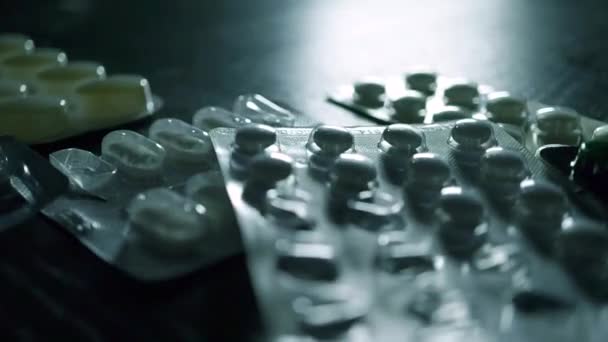 Different pills blister packs fall on black table. 2 slow motion videos in 1 — Stock Video