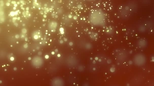 Golden blurred luminous particles falling slowly against red background — Stock Video