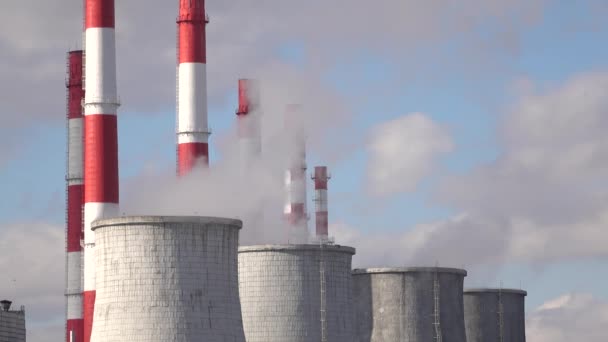 Smoke stacks and cooling towers against cloudy sky — Stock Video