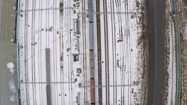 Many electrified railroad tracks and switches in winter. Aerial shot from above — Stock Video