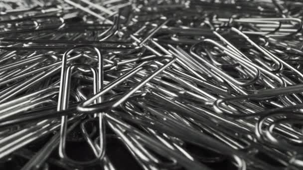 Big pile of paper fasteners, close up dolly video — Stock Video