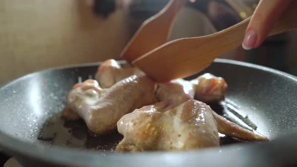 Turning over chicken wings on a grill frying pan, slow motion video — Stock Video