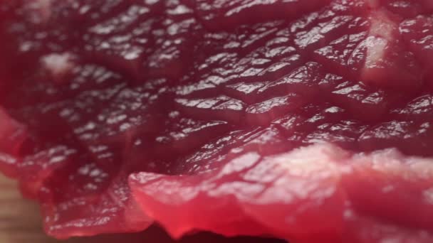 Macro dolly shot of three small fresh beef pieces — Stock Video