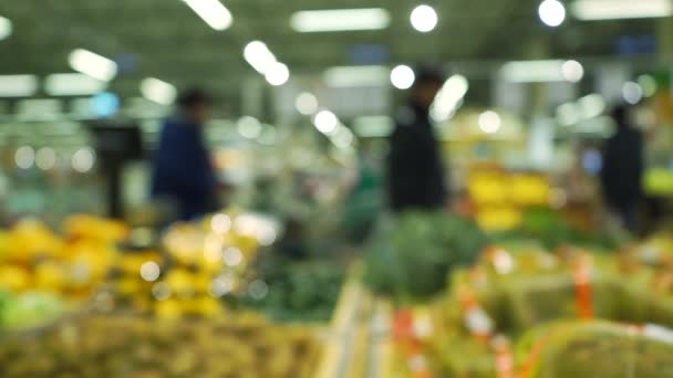 Pessoas desfocadas comprando frutas em um supermercado. Vídeo em câmera lenta — Vídeo de Stock
