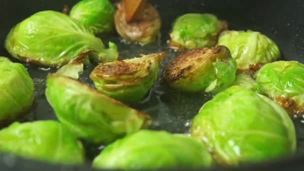 Turning over fried Brussels sprouts close up shot — Stock Video