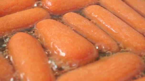 Roasting small carrots macro shot — Stock Video