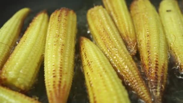 Roasting small corn cobs, macro dolly shot — Stock Video