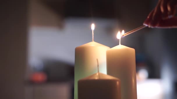 Girl hand lighting up three candles — Stock Video