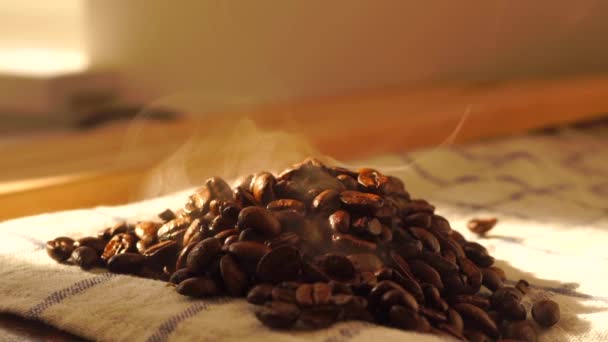 A pile of smoking roasted coffee beans on a towel — Stock Video