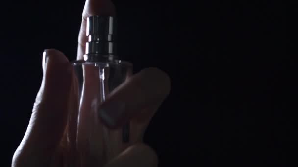 Beautiful woman hand sprays perfume at the camera, slow motion video — Stock Video