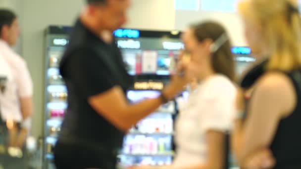 Un video confuso di Bokeh. Lezione di trucco. Truccatore e bella ragazza bruna — Video Stock