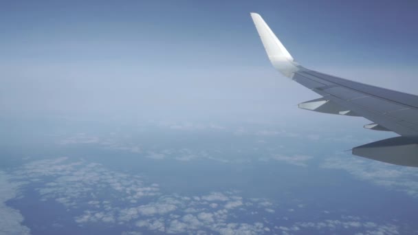 Airliner flying high above the clouds. Porthole view, aerial video — Stock Video