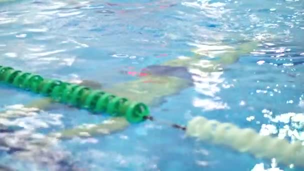 Young handsome man climbs out of the swimming pool. Close up slow motion shot — ストック動画