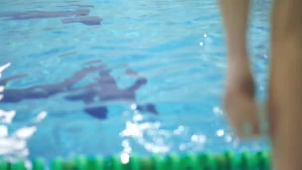 Unrecognizable man diving in the swimming pool. Slow motion close up shot — Stock Video