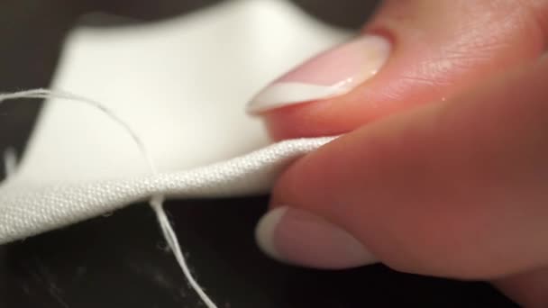 Lindas mãos de mulher jovem costurando um pano branco. Macro vídeo — Vídeo de Stock