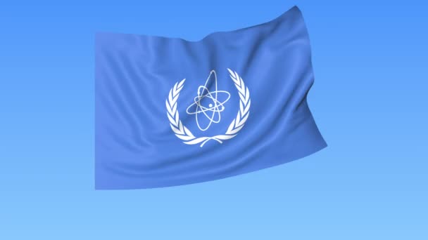 Die Internationale Atomenergiebehörde IAEA flattert Flagge. nahtloses Looping, 4k-Vorstufen mit Alpha-Kanal — Stockvideo