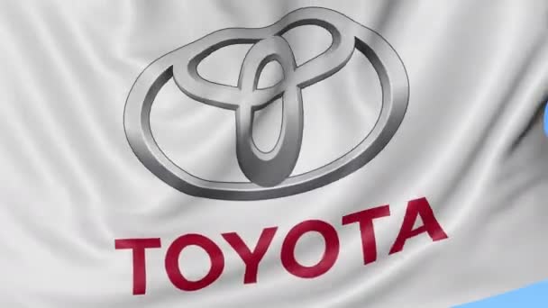 Крупним планом розмахуючи прапор з Toyota логотип, безшовні петлю, синьому тлі. Редакційна анімації. 4 к Prores, alpha — стокове відео