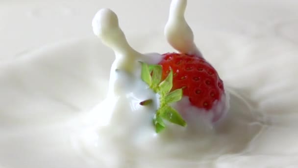 Super slow motion video van aardbei spatten in crème — Stockvideo