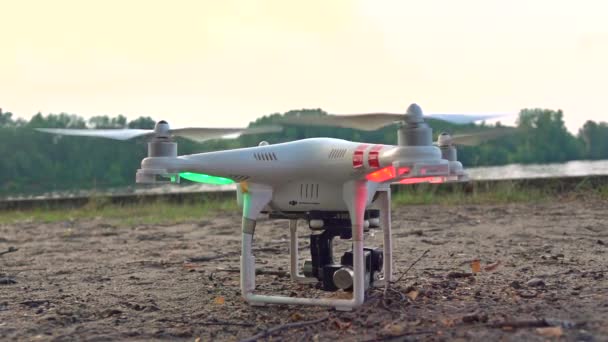 MOSCOW, RUSSIA - July, 30, 2016. DJI Phantom drone taking off from sand at sunset. Super slow motion shot — Stock Video