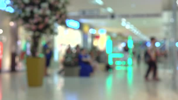 Unknown people walking in modern shopping mall. 4K bokeh video — Stock Video