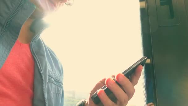 Man using his smartphone in the train. Tapping on device touchscreen. 4K close up shot — Stock Video