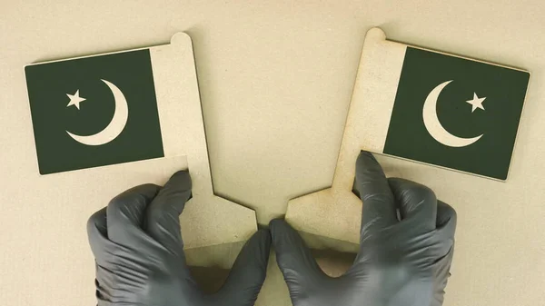 Flags of Pakistan made of recycled paper on the cardboard table — Stock Photo, Image