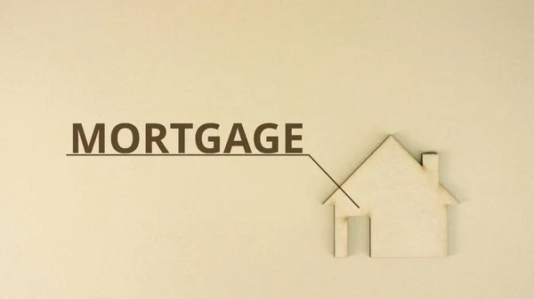 Cardboard home icon with MORTGAGE text on the table — Stock Photo, Image
