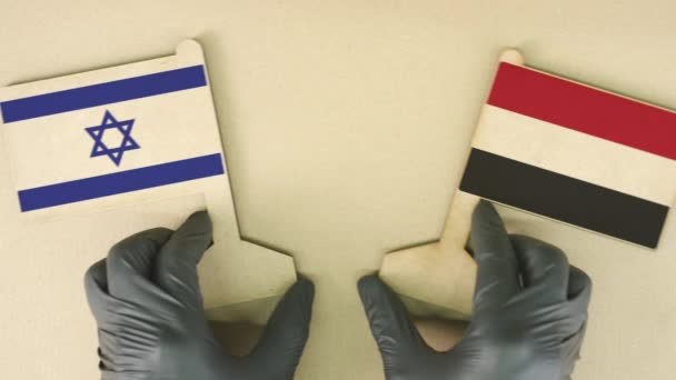 Flags of Israel and Yemen made of recycled paper on the cardboard table — Stock Video