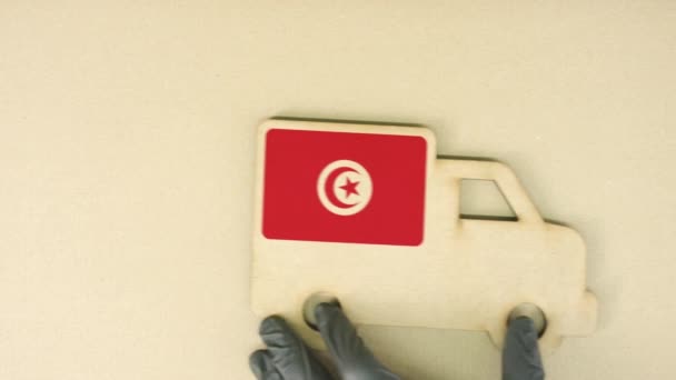 Flag of Tunisia on the recycled cardboad truck icon, national sustainable logistics concept — Stock Video