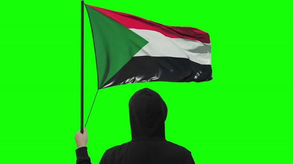 Flagge des Sudan und unbekannter Mann, isoliert auf grünem Hintergrund — Stockfoto