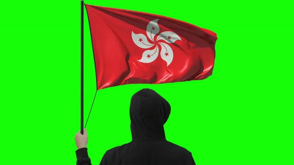 Okänd man innehar viftande flagga Hongkong, isolerad på grön bakgrund — Stockfoto
